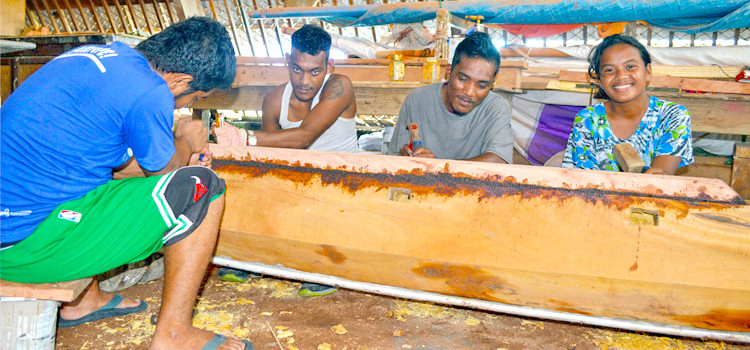 WAM trainees Reghie Lucky, March Enos, Janen Torelik and Jeitha Jennop at work on a canoe. Photo: Karen Earnshaw. Guarantee of jobs for WAM trainees