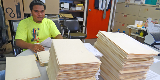 Third-year College of Marshall Islands student Brandon Jolbo Bartimues is assisting the Nuclear Claims Tribunal to digitize its records. Photo: Hilary Hosia Nuclear Tribunal records being preserved