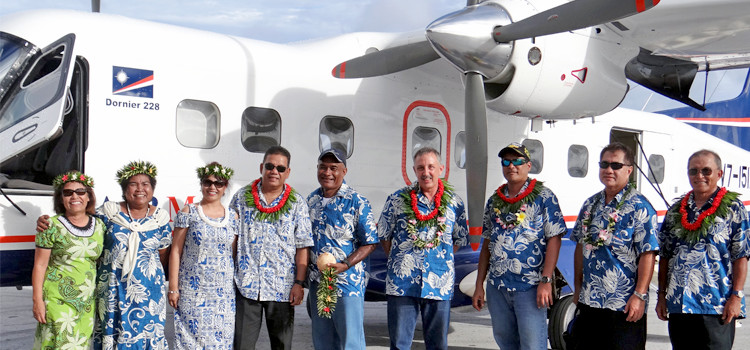 VIPs and AMI flight crew pose with the Dornier 228 that arrived from Manila on Tuesday. Photo: Hilary Hosia. AMI’s Dornier arrives