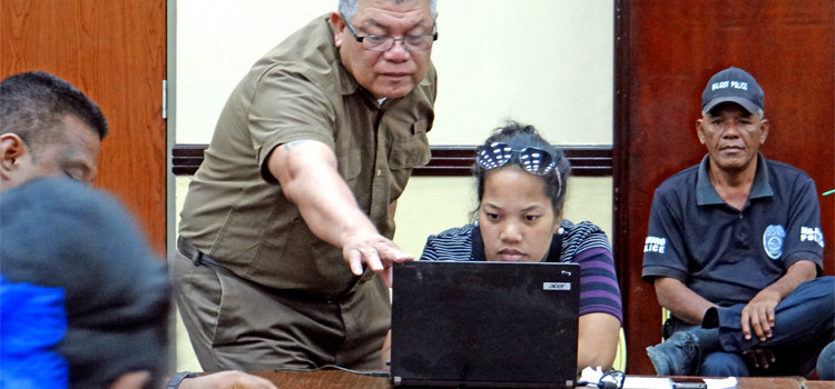 Chief Electoral Officer Robson Almen checks the postal absentee list with Electoral staff member Rosemita Lokeijak on Tuesday December 1 as Electoral staff began the process of sorting and vetting incoming postal absentee affidavits and ballots at the ICC tabulation headquarters in Majuro. Photo: Hilary Hosia. Domestic Election Results