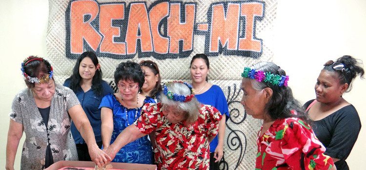 Maria Capital (left) and Lemeyo Abon (right) joined REACH-MI President Rosania Bennett to cut the cake officially launching the new organization. Photo: Giff Johnson. Breathing life into nuclear issue