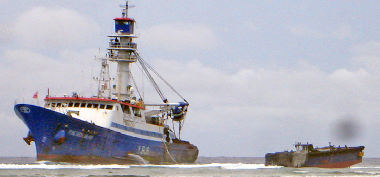 The purse seiner Fong Seong 666 has been stuck on the ocean side reef near Bokwa-lokojlo Island, on Majuro’s north shore, since late last week. Photo: Matt Holly. Seiner grounded in Majuro