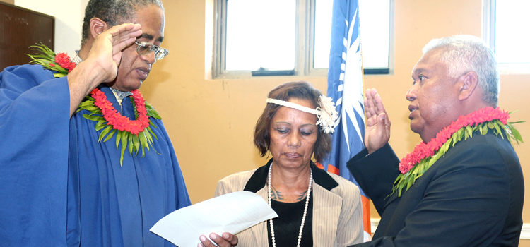 High Court Chief Justice Carl Ingram (left) administered the oath of office for Ambassador Gerald Zackios as Likiep Mayor Nika Wase held the Bible. Photo: Denise deBrum-Reiher. Gerald sworn in for DC duty