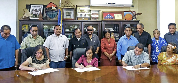 RMI leaders, seated from left, Minister Amenta Matthew, President Hilda Heine, and Marshall Islands Mayors Association President Ota Kisino sign the Leadership Conference joint communique as national and local leaders look on. Photo: Hilary Hosia. Leaders sign plan of action