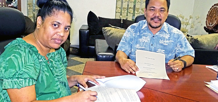 Nitijela Clerk Morean Watak (left) and Speaker Kenneth Kedi sign Bill No. 6 into law Tuesday following a meeting with the Council of Iroij earlier in the day. Photo: Hilary Hosia. Bill 6 signed into law