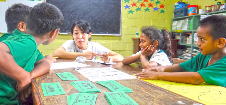 Rairok Elementary open class third grade students work with UES JICA Volunteer math teacher Tomoko Kamochi. Photo: Hilary Hosia. Rairok shows math skills