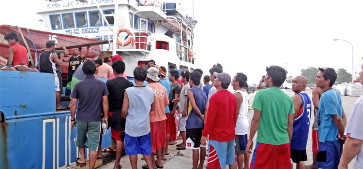 Crew reboard a fishing boat from the Philippines that was denied entrance to the RMI last week Thursday. It is being held at Uliga Dock in Majuro pending a decision from authorities. Photo: Hilary Hosia. Fishing boat held at Uliga Dock