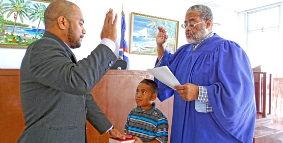 Nitijela Legislative Counsel Joe Lomae is sworn in by Chief Justice Carl Ingram while his son Jordan holds the Bible. Photo: Hilary Hosia. Joe Lomae joins RMI Bar