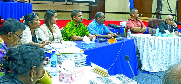 Auditor General Junior Patrick (third from right) speaks to the Committee of the Whole at ConCon Tuesday as chairman Delegate Jack Ading (far right), Delegate David Paul listen. Auditor General staff and other ConCon delegates are at left. Photo: Hilary Hosia. Patrick: We need action