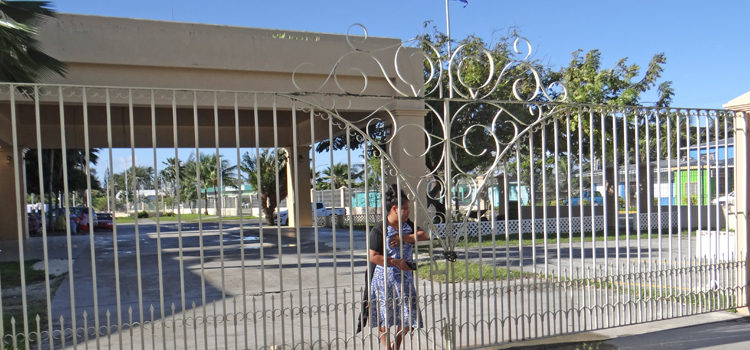 Nitijela Clerk Morean Watak stands next to the locked gate in the driveway between Nitijela and the International Conference Center in Majuro that was locked by landowners Tuesday and Wednesday. Photo: Hilary Hosia. Owners lock up Nitijela