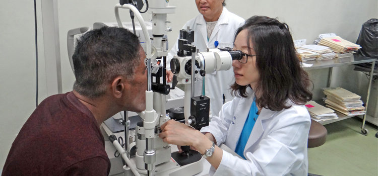 Dr. Shih-Wen Wang works with Mija Kaious while nurse Nosie Minor observes. Photo: Hilary Hosia Big crowd to see eye doc