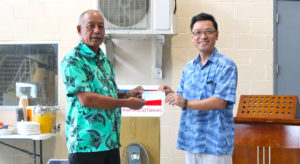 Minister Dennis Momotaro receives solar check from Taiwan Ambassador Daniel Tang.