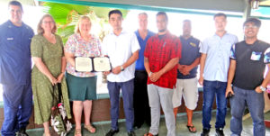 US Ambassador Karen Stewart and her staff present an award to Pan Pacific Foods CEO Wanjun Yang and staff.