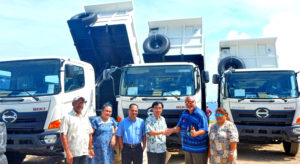 Japan Ambassador Hideyuki Mitsuoka handed over to Minister Tony Muller three dump trucks and spare parts for heavy equipment donated earlier, as other VIPs look on.