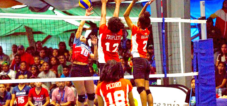RMI women’s volleyball players Sidra Triplett and Aliyah Brown stretch to block a Guam spike, as Rutha Pedro readies to defend. Photo: 9th Micronesian Games Media. RMI volleyball women set pace