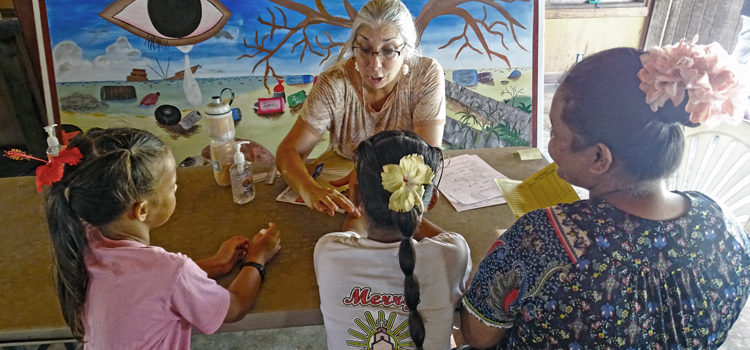 Mary DaSilva checks TB tests of a mother and her two daughters at the screening center located at the Youth to Youth in Health youth community center in Majuro earlier this month. DaSilva is a TB nurse from Austin, Texas who is volunteering with the mass TB screening program in Majuro. TB screening hits 70% mark