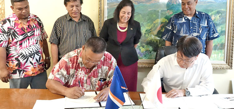 Utrok Mayor John Kaiko and Japan Embassy Charge Hiroshi Watanabe sign a grant agreement for funding to build a fish base on the northern atoll. Utrok gets fish base