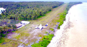 An Air Marshall Islands plane parked next to the airport terminal on Lae Atoll. Photo: Tyler Milne.