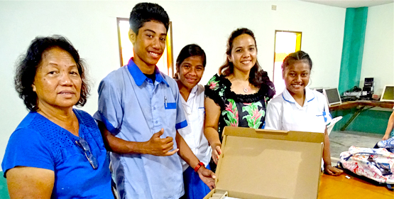 Assumption Principal Biram Stege, left, and daughter and fundraiser Tina Stege, second from right, with Assumption High School students receiving the new laptops at the school in Majuro. Photo: Kelly Lorennij. Laptops a hit at Assumption