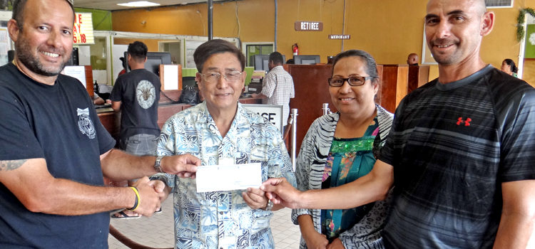 Marshall Islands Basketball Federation President Sherwood Tibon, left, and member at large Robert Pinho, right, accept a check from Bank of Marshall Islands President and CEO Patrick Chen and BOMI Executive Secretary Marilyn Harry for the BOMI 18th Ralik Ratak Shootout Basketball Tournament. BOMI is the major sponsor for the basketball showcase tourney. Photo: Hilary Hosia. Lae men take fifth straight title