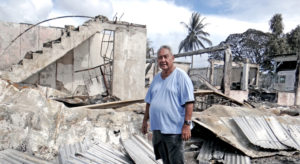 DAR founder Charles Domnick stands outside the former Israeli Consulate office, part of the fire-destroyed DAR complex. Photo: Hilary Hosia.