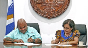 MICNGOs President Alson Kelen, left, and RMI President Hilda Heine signed the first-ever Partnership Framework Agreement for civil society last week in Majuro. Photo: Hilary Hosia.