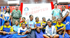 Foreign Ministers John Silk of the RMI and Jaushieh Joseph Wu of ROC/Taiwan, left and right of “visa waiver” banner, respectively, joined students from Assumption, Majuro Baptist Academy and Delap Elementary in celebration at the International Conference Center Tuesday. Photo: Hilary Hosia.