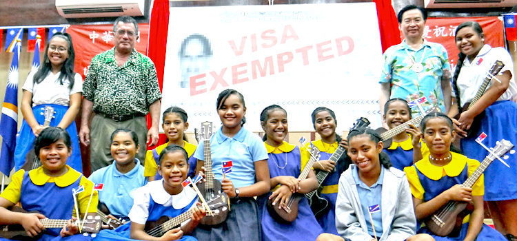 Foreign Ministers John Silk of the RMI and Jaushieh Joseph Wu of ROC/Taiwan, left and right of “visa waiver” banner, respectively, joined students from Assumption, Majuro Baptist Academy and Delap Elementary in celebration at the International Conference Center Tuesday. Photo: Hilary Hosia. ‘Institutionalizing’ RMI-ROC ties