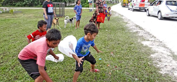 Children in Laura go for the candy being tossed from passing floats during last Saturday’s Christmas parade. The parade was organized by the Trust Company of the Marshall Islands. Photo: Hilary Hosia. Better late than never
