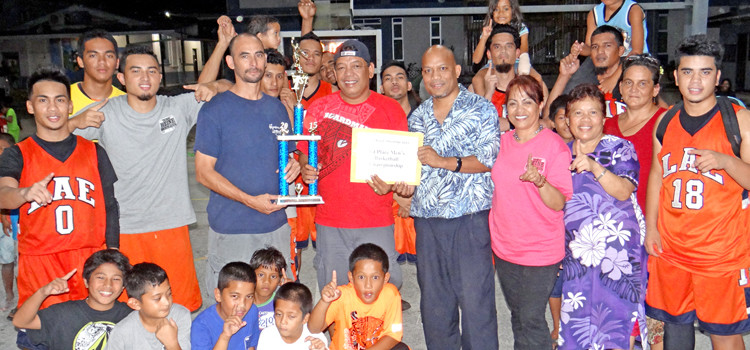 Team Lae Coach Thomas Heine receives the championship $1,000 prize from BOMI representative Arlington Tibon and the trophy from MIBF board member Robert Pinho. Photo: Hilary Hosia. Lae wins 15th BOMI shootout
