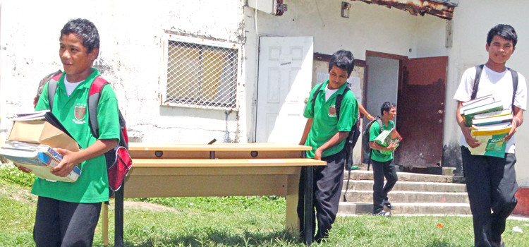 Life Skills Academy students help move furniture and books from the derelict building. Photo: Hilary Hosia LSA loses school