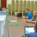 CEO Robson Almen (center at right) briefs Electoral staff prior to the start of checking all incoming postal ballots at the ICC in Majuro. The five locked boxes containing postal ballots are lined up at left. Photo: Hilary Hosia.