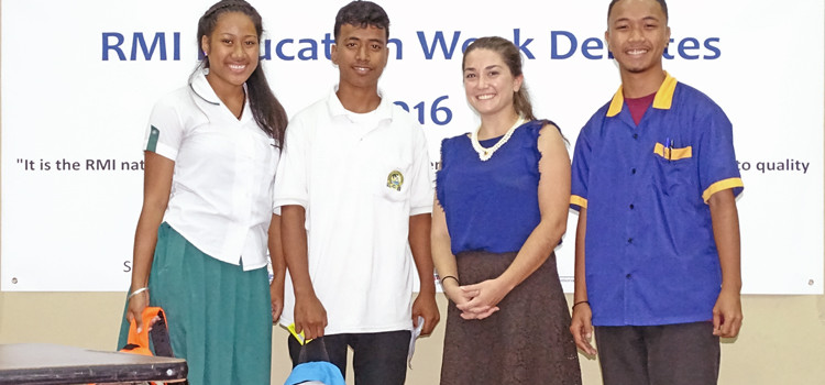 Debate champions Kina Jordan (left) and Julius Edward were recognized by debate Coordinator WorldTeach Director Erin Gerard and last year Education week debate champs