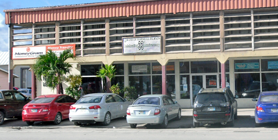 The parking lot in front of the main branch of Bank of Marshall Islands was the scene of an arrest last week. Quick! Hide the gun