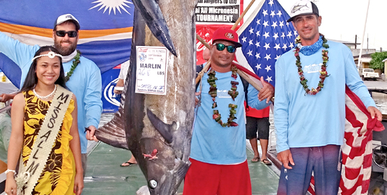 A smiling Miss All-Micronesia Tammie Shoniber with Team Santo Island #2 Captain Chad McGlinn and teammates. They tagged two Tuna, weighed in a 29-lb. Wahoo (2nd place) and this first place 268-lb. Pacific Blue Marlin. Photo: Hilary Hosia. 24th All-Micronesia: The Tag-n-Release fishing tournament