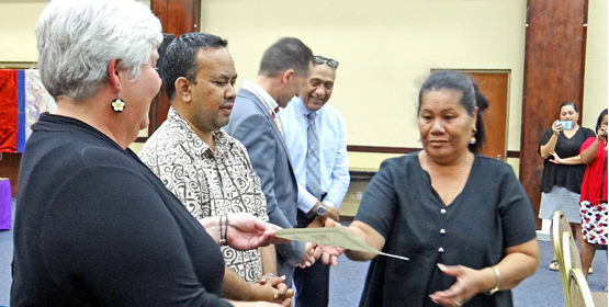 US Embassy Deputy Chief of Mission Sarah Nelson and Acting President Mattlan Zackhras congratulated trafficking workshop graduate Totha Keju. Photo: Hilary Hosia. RMI focusing on trafficking