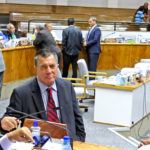 During a break in the on-air debate, Nitijela members huddle in the chamber. Foreground: Kwajalein Senator David Paul (seated), Foreign Minister John Silk, and Education Minister Wilbur Heine. Photo: Hilary Hosia.