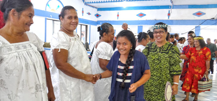 Queena Loeak joined grandmother Jacqueline Loeak to welcome the visiting Kosraen group to Majuro following Sunday’s church service at Uliga Protestant Church. Rev. Enja Enos is visible at the podium at back. Photo: Hilary Hosia. Utwe likatus in spotlight