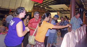Jambo Arts President Angela Saunders (left) and Marshallese Be Like Film Festival attendees cast their votes for favorite films shown at Jitak En Likatu Bar Friday. Photo: Hilary Hosia.