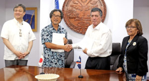 Japan Vice Minister of Foreign Affairs Iwao Horii (left) joined President Hilda Heine (right) at the signing ceremony for a new Japan-funded solar project for Ebeye Island. Signing the grant pact was Japan International Cooperation Agency Resident Representative Nobuaki Matsui and Foreign Minister John Silk.