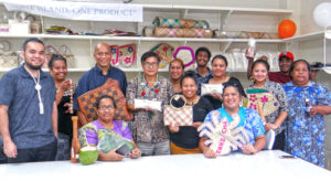 Bank of Marshall Islands President Patrick (center holding bag of Ebon flour) joined with Arlington Tibon (third from left), Marshall Islands Service Corporation and BOMI staff at the opening of the new Local Market in Uliga. Photo: Hilary Hosia.