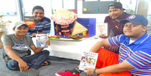 College of the Marshall Islands students show off some of the nuclear weapons testing-related material at the special exhibit on display at the CMI library. Photo: Kelly Lorennij.