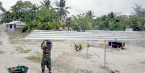 Workers at Enewetak Atoll install platforms for a solar panel array that is now powering a new reverse osmosis water-making unit on the former nuclear weapons test site.