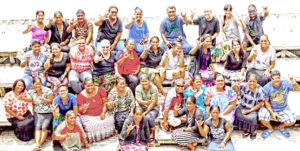 Teachers studying in CMI’s Navigating Student Success in the Pacific program sign the word “love” at CMI. Photo: Kelly Lorennij.