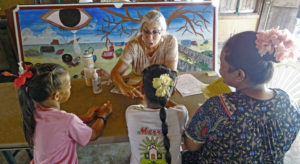 Mary DaSilva checks TB tests of a mother and her two daughters at the screening center located at the Youth to Youth in Health youth community center in Majuro earlier this month. DaSilva is a TB nurse from Austin, Texas who is volunteering with the mass TB screening program in Majuro.