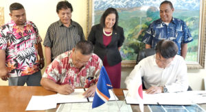 Utrok Mayor John Kaiko and Japan Embassy Charge Hiroshi Watanabe sign a grant agreement for funding to build a fish base on the northern atoll.