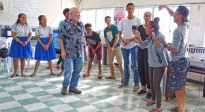 A rehearsal session for The Music Man gets the actors involved in learning how to express themselves for the musical. Professor Andrew Garrod is in the center, with Dartmouth Students Tyler Malbreaux and Summer Cody at right with local students. Photo: Hilary Hosia.