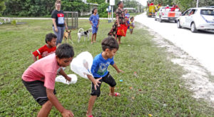 Children in Laura go for the candy being tossed from passing floats during last Saturday’s Christmas parade. The parade was organized by the Trust Company of the Marshall Islands. Photo: Hilary Hosia.