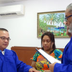 New District Court Presiding Judge Ablos Paul was sworn into his new post last Thursday by Chief Justice Carl Ingram. Holding the Bible is Judge Paul’s wife Helena. Photo: Hilary Hosia.