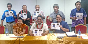 Nitijela Public Accounts Committee joined with Judiciary representatives after the public hearing on the Judiciary audit. Seated, from left: Deputy Clerk of Courts Tanya Lomae, PAC Chairman Senator Bruce Bilimon, and Chief Clerk of Courts Ingrid Kabua showing the flow chart provided by the Judiciary to the PAC Committee. Standing, from left: Senators Eldon Note, David Kabua, Atbi Riklon, Tony Aiseia and Vice Speaker Jejwarick Anton.